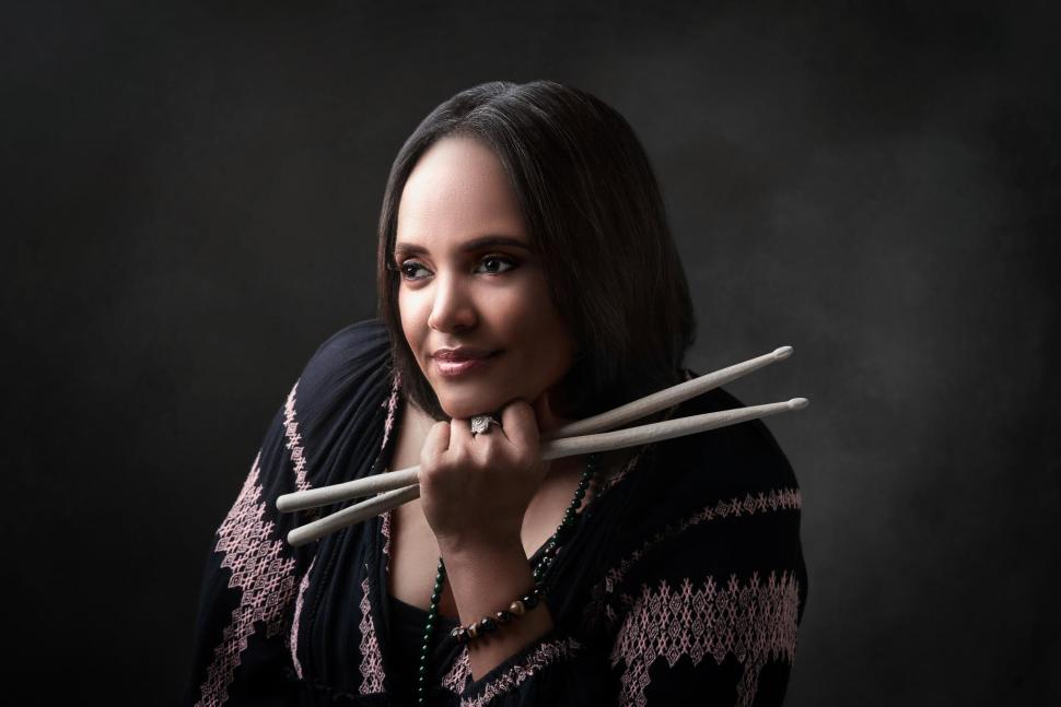 Portrait of a woman holding two drum sticks