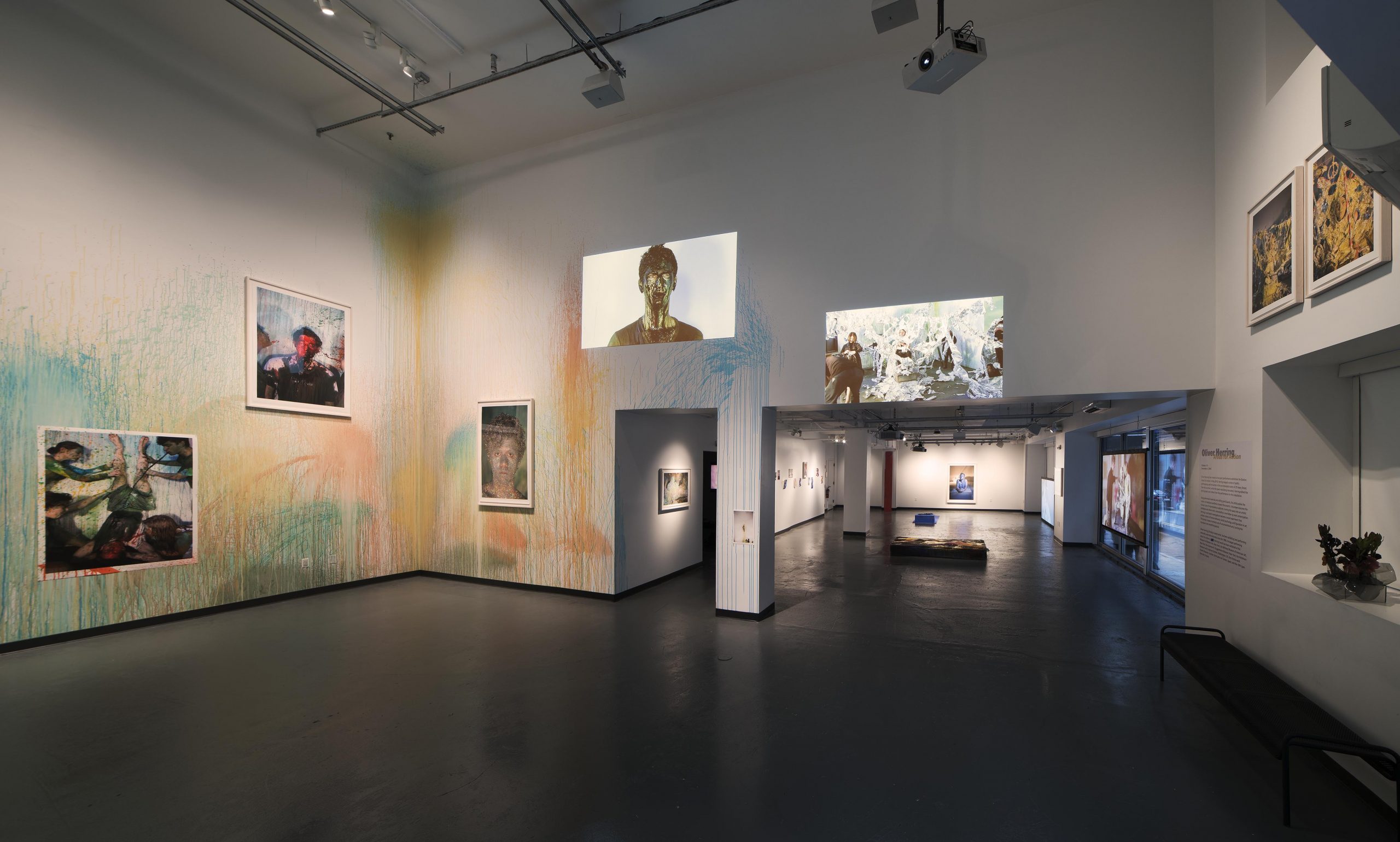 areas for action exhibit with paint covered walls and images of paint covered people