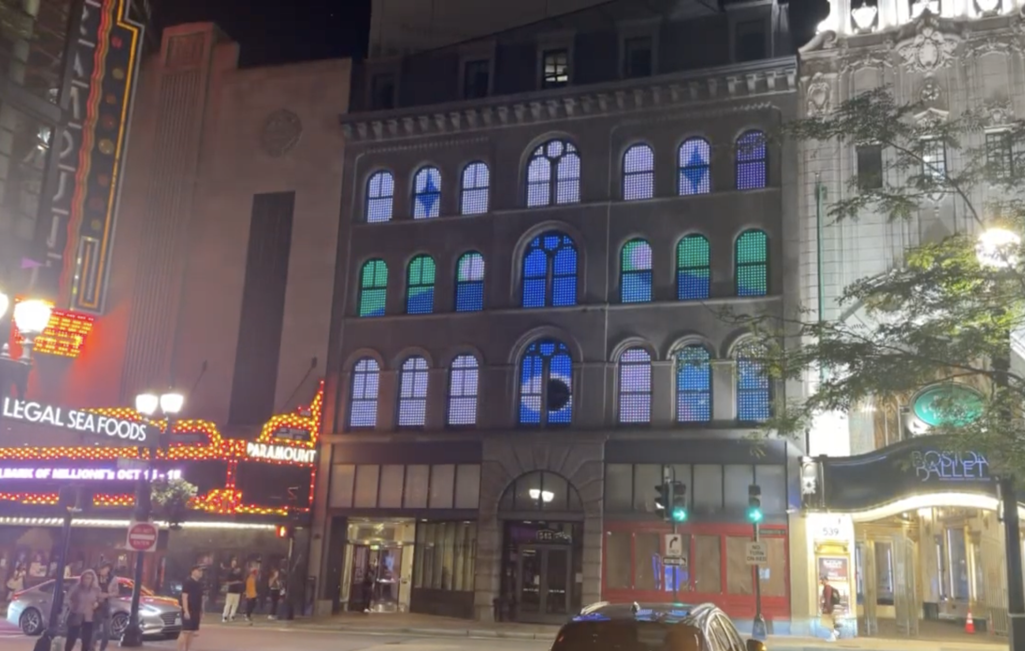 Nighttime image of paramount center with facade illuminated by digital art.